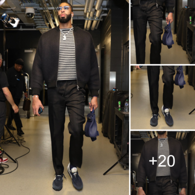 Anthony Davis wears an all-black ensemble that includes a Jil Sander zip sweater that costs $1317 and a blue Hermes satchel that costs $15,721